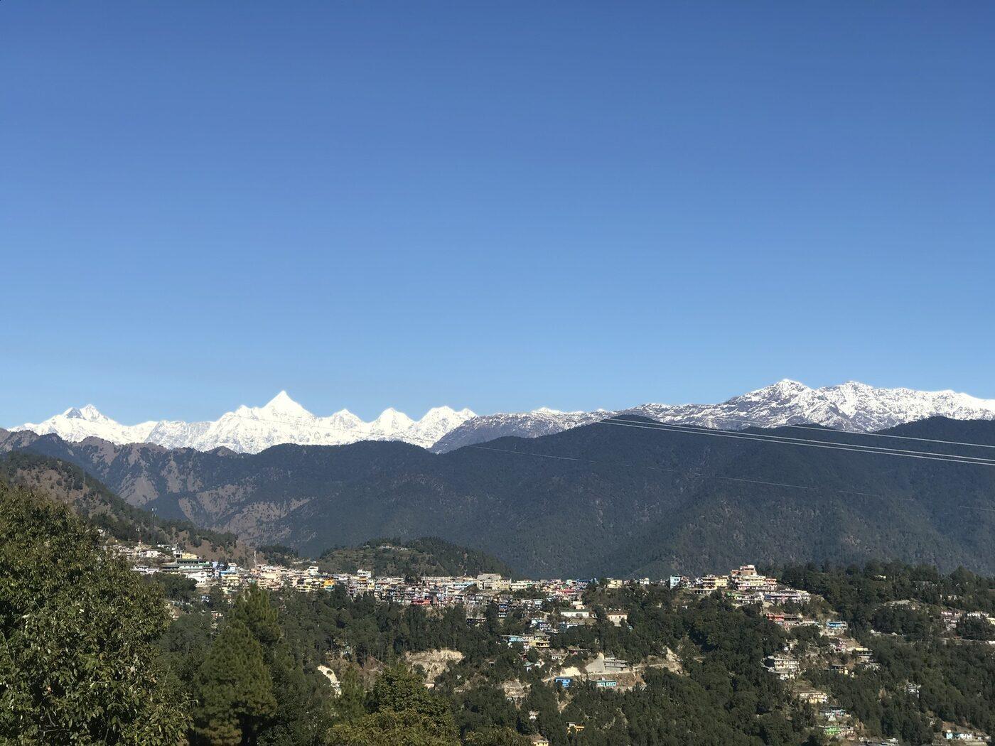 Didihat town with the snow-capped Panchachuli range behind it, in the valley that grew from Hat Tharp